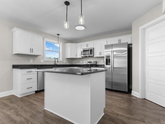 kitchen with white cabinets, stainless steel appliances, and pendant lighting