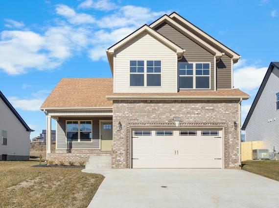 craftsman inspired home with a front lawn, a garage, and central air condition unit