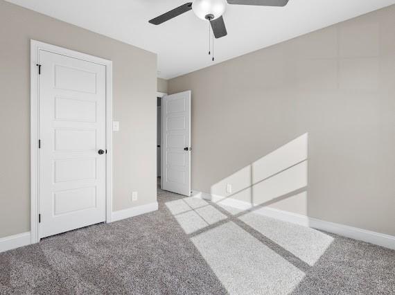 unfurnished bedroom with ceiling fan and light carpet