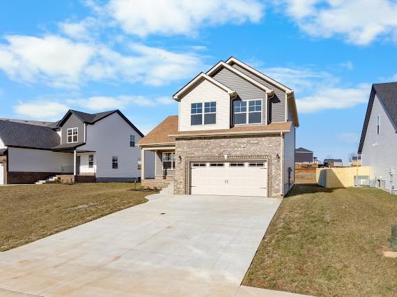 craftsman inspired home with a garage and a front lawn