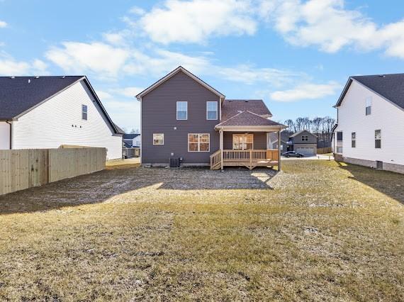 back of house with a lawn and central air condition unit