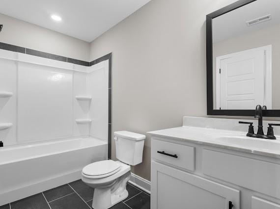 full bathroom with vanity, toilet, tile patterned floors, and tub / shower combination