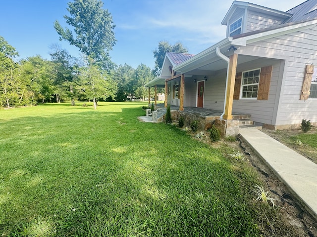 view of yard with covered porch