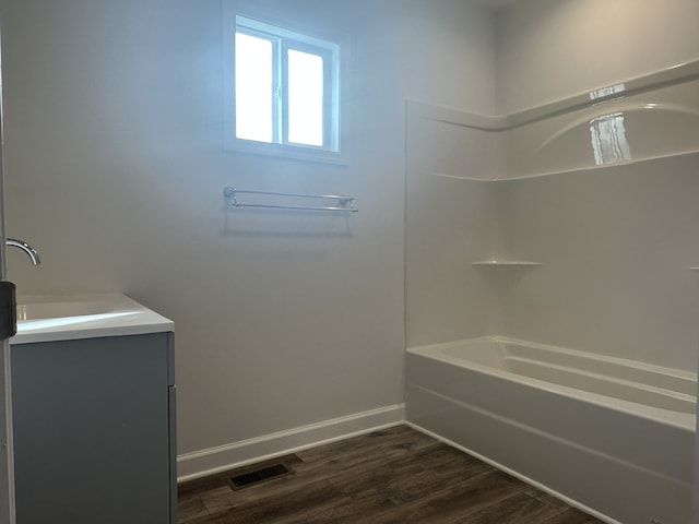 bathroom with vanity, shower / bath combination, and hardwood / wood-style flooring