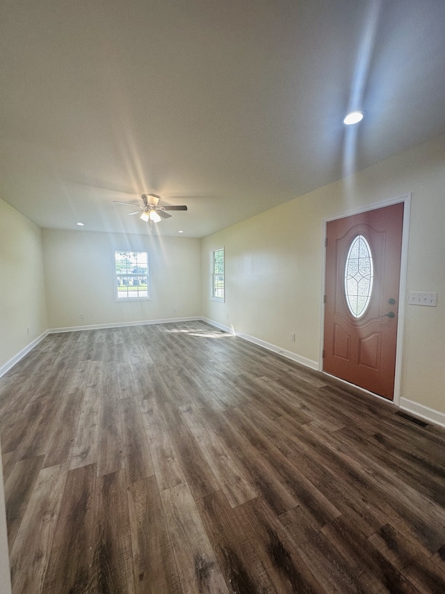 foyer entrance with dark wood-type flooring and ceiling fan