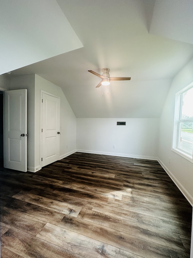 bonus room with dark hardwood / wood-style flooring, ceiling fan, and vaulted ceiling