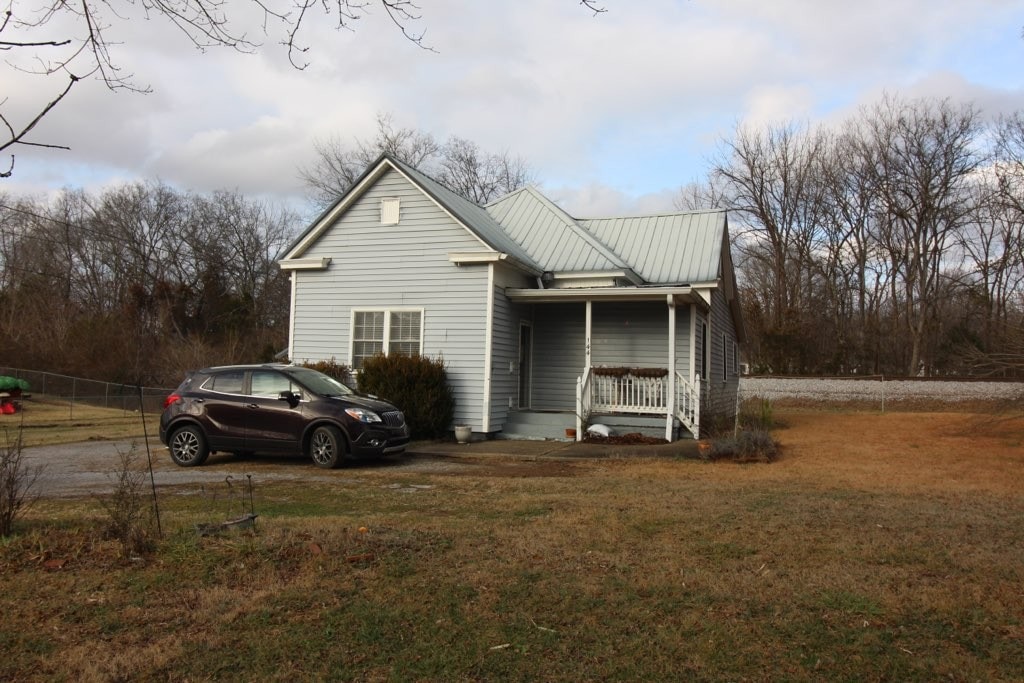 exterior space with a front yard and a porch