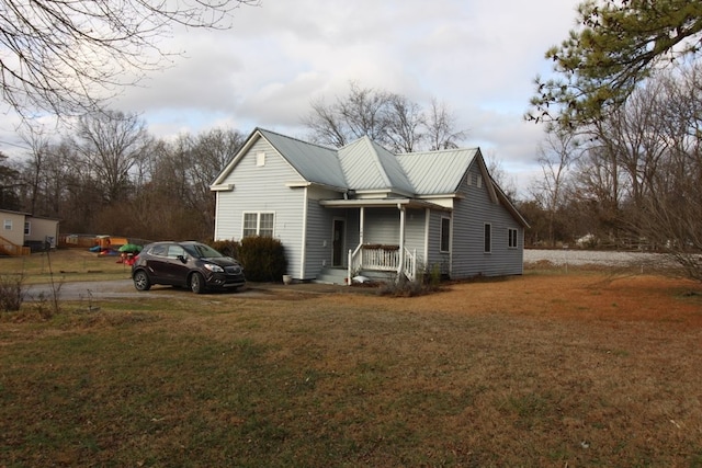 view of front of home featuring covered porch and a front yard