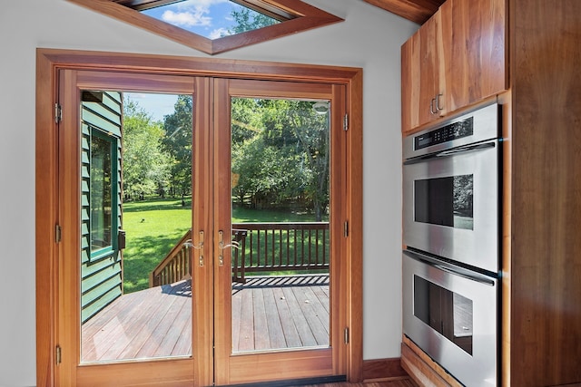 doorway to outside featuring french doors and a skylight