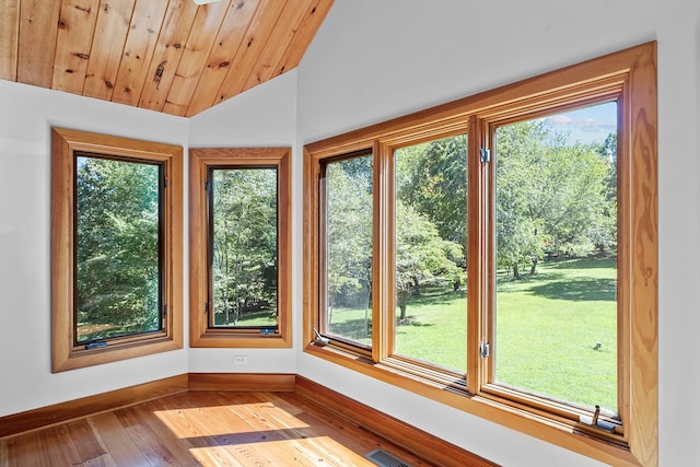 unfurnished sunroom with wood ceiling, vaulted ceiling, and a wealth of natural light