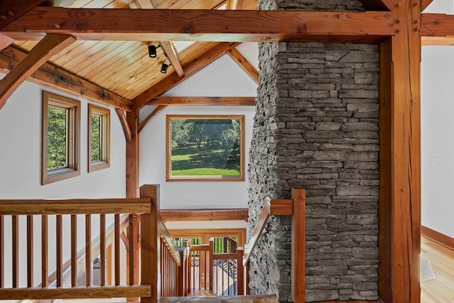 interior space featuring vaulted ceiling with beams and wood-type flooring