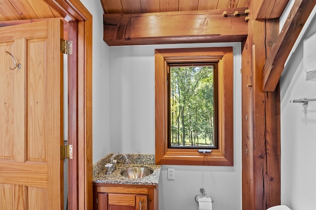 bathroom with wooden ceiling and vanity