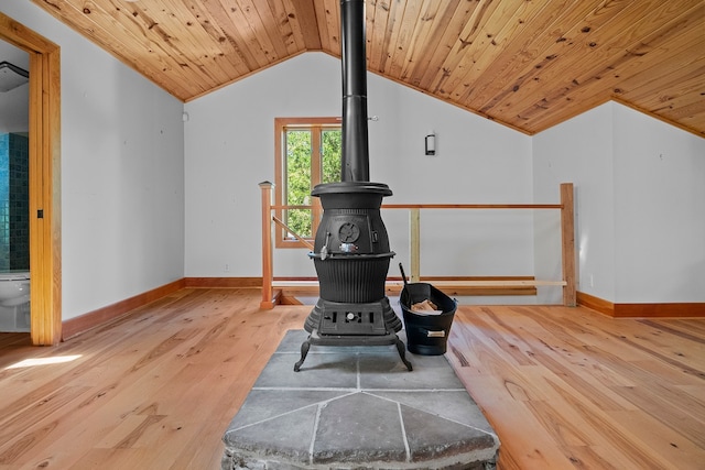 interior space featuring a wood stove, wood ceiling, and light hardwood / wood-style floors