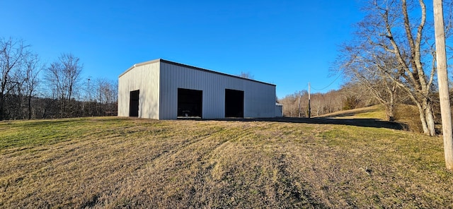 view of outdoor structure with a yard and a garage