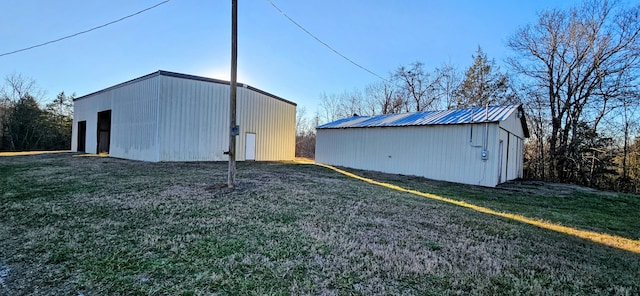 view of shed / structure with a yard and a garage