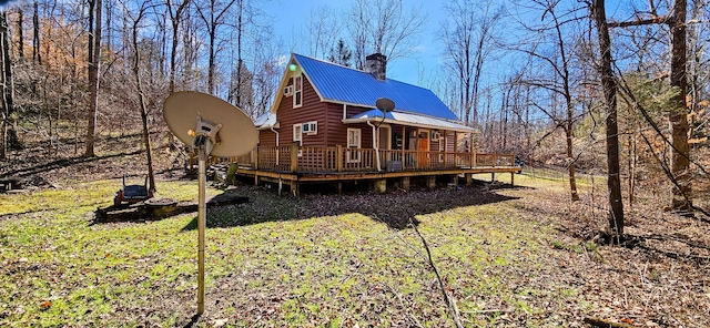 back of property featuring a yard and a deck