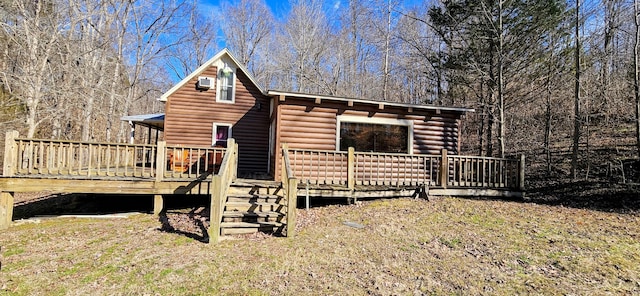 back of house featuring a wooden deck