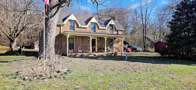 new england style home with covered porch and a front lawn