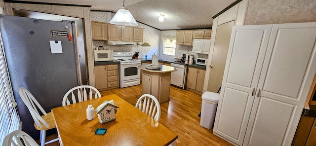 kitchen with a kitchen island, extractor fan, white appliances, hanging light fixtures, and light wood-type flooring