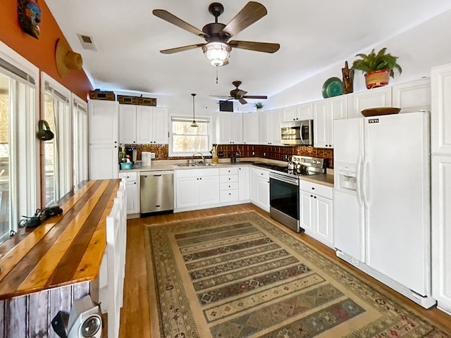 kitchen featuring backsplash, stainless steel appliances, ceiling fan, and white cabinetry