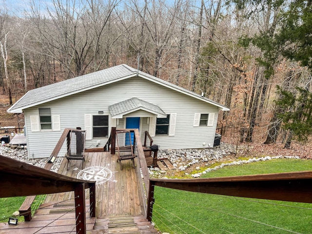 view of front of home featuring a front lawn and a deck