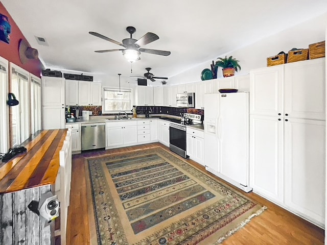 kitchen with butcher block countertops, ceiling fan, stainless steel appliances, dark hardwood / wood-style flooring, and white cabinets