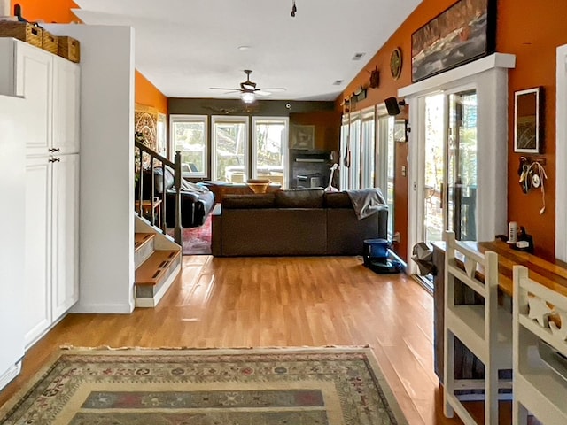 living room featuring ceiling fan and light wood-type flooring