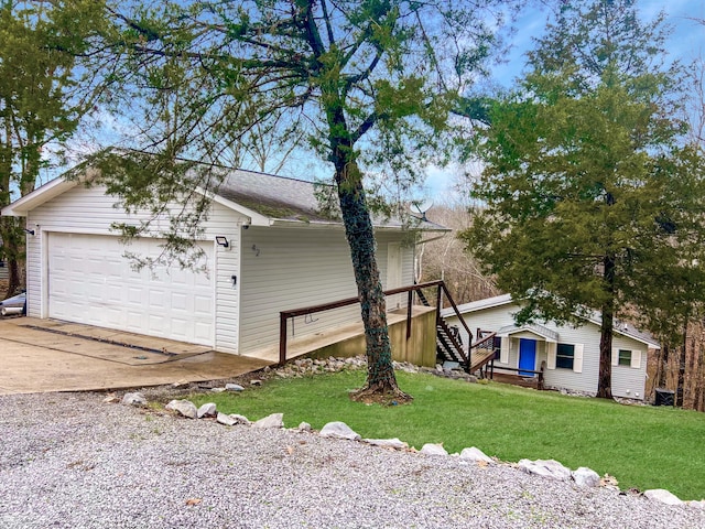 view of side of home featuring a lawn and a garage