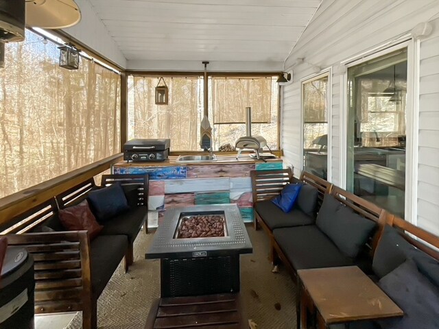 sunroom featuring plenty of natural light and lofted ceiling