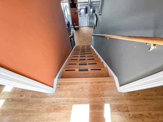 stairway with hardwood / wood-style floors