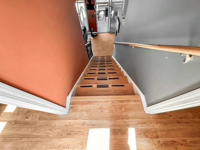 staircase with dark hardwood / wood-style floors