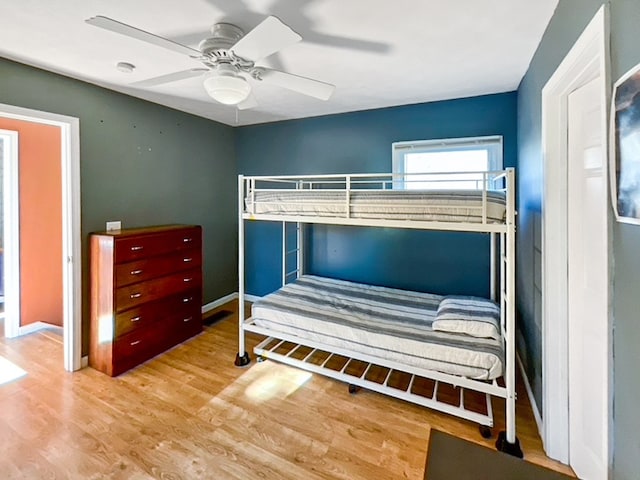 bedroom with ceiling fan and light wood-type flooring