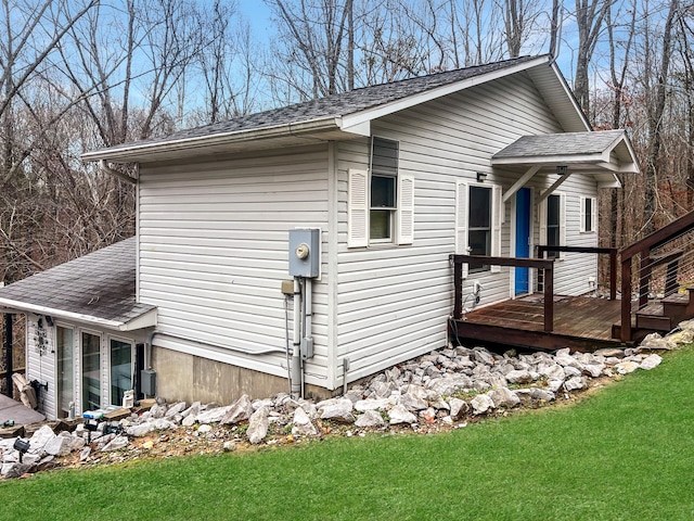 exterior space with a wooden deck and a lawn