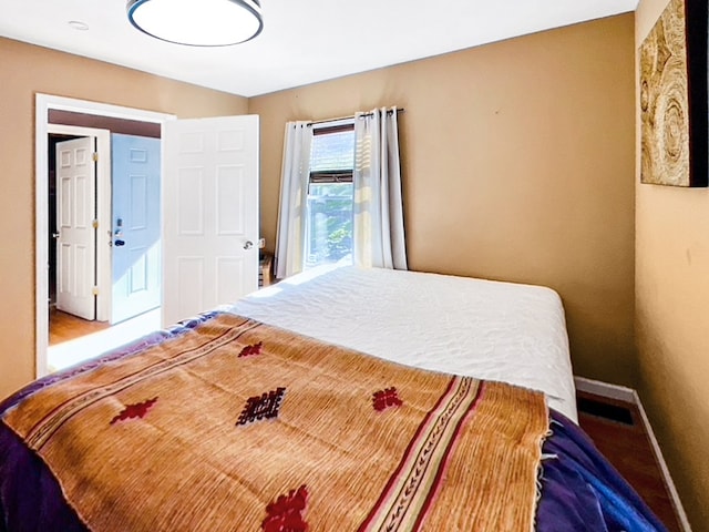 bedroom with hardwood / wood-style flooring