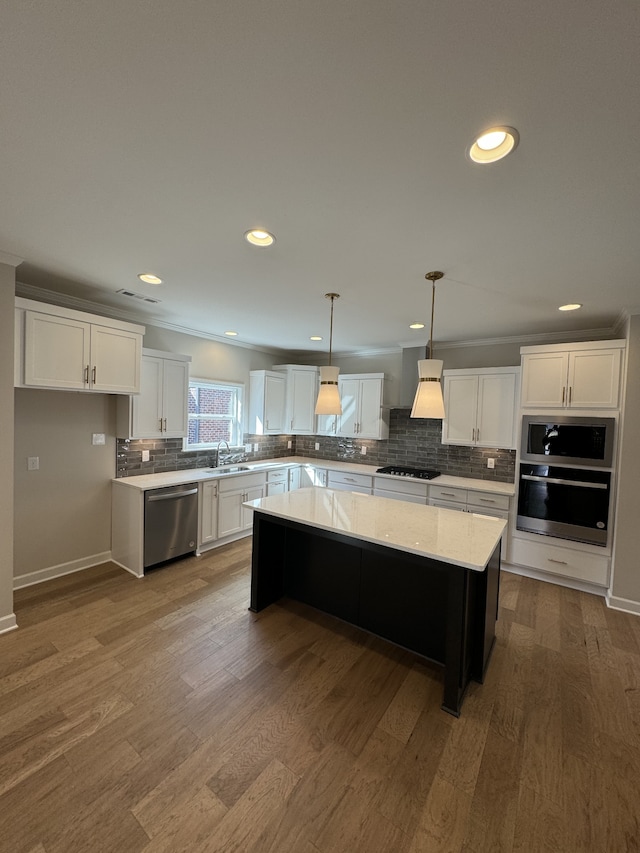 kitchen featuring white cabinets, stainless steel dishwasher, and a kitchen island