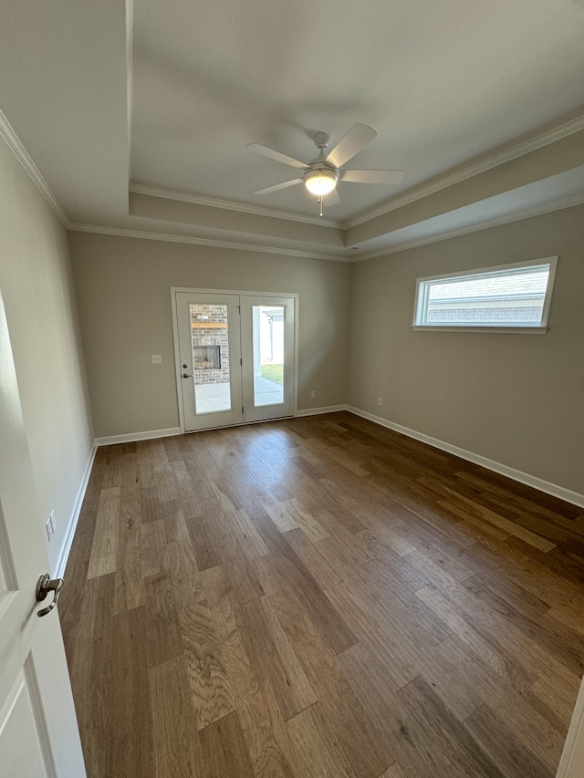 spare room featuring ceiling fan, a raised ceiling, crown molding, and hardwood / wood-style floors