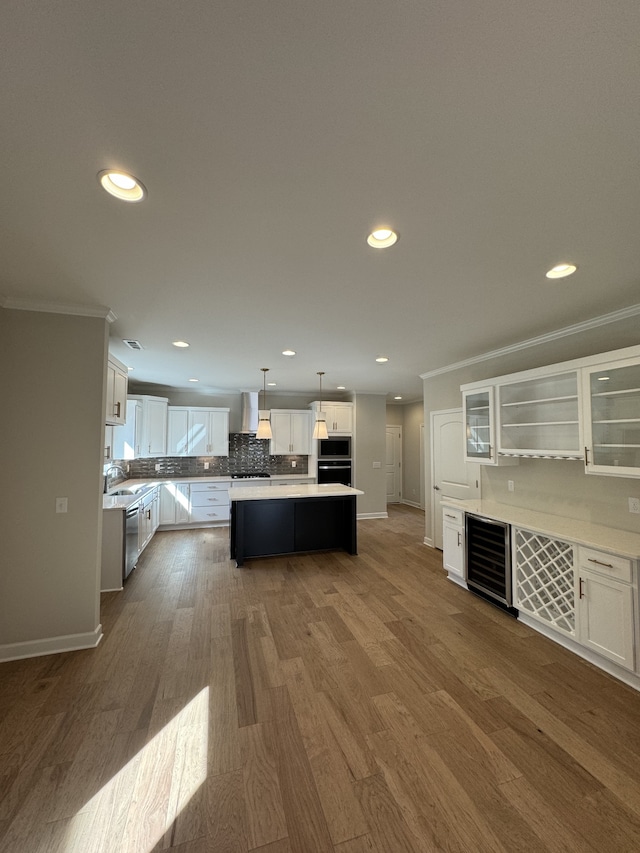 kitchen featuring sink, a kitchen island, white cabinetry, pendant lighting, and dark hardwood / wood-style floors