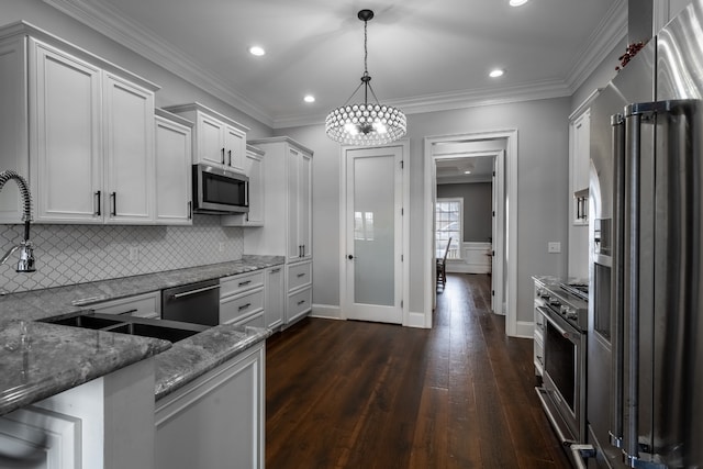 kitchen featuring hanging light fixtures, dark hardwood / wood-style flooring, stone countertops, tasteful backsplash, and high quality appliances