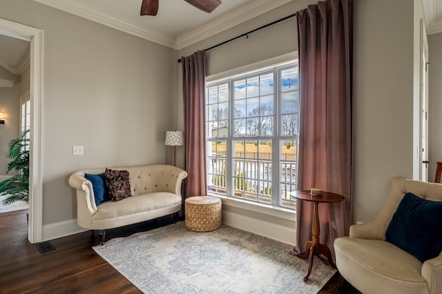 living area with ceiling fan, ornamental molding, and dark wood-type flooring