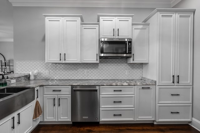 kitchen with white cabinets, light stone countertops, and dark hardwood / wood-style floors