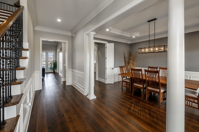 dining room featuring ornamental molding, dark wood-type flooring, and ornate columns