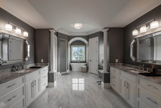 bathroom with decorative columns, a bathing tub, double vanity, tile flooring, and crown molding