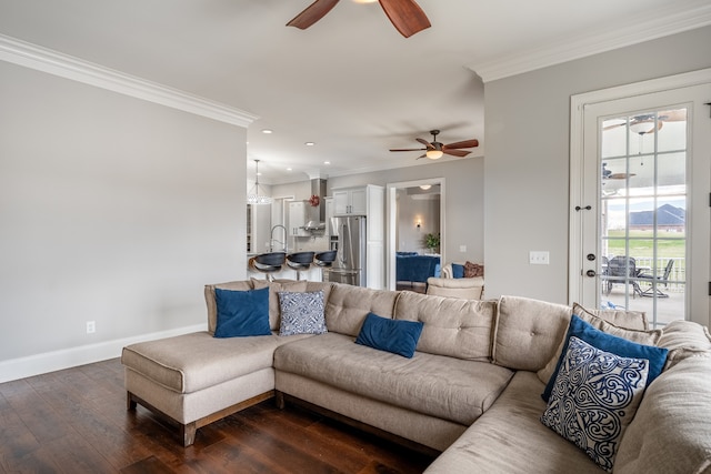 living room with ceiling fan, crown molding, sink, and dark hardwood / wood-style floors