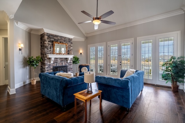 living room with ceiling fan, a fireplace, a wealth of natural light, high vaulted ceiling, and crown molding