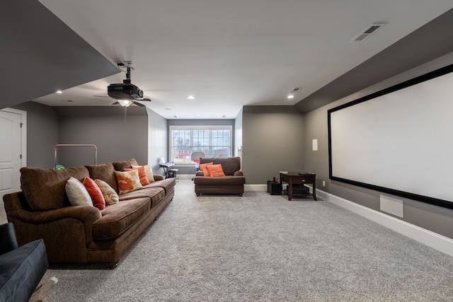 carpeted cinema room featuring ceiling fan