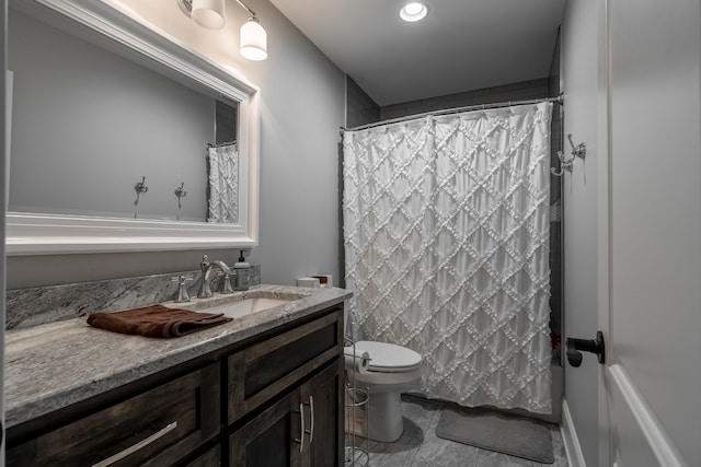 bathroom featuring toilet, tile floors, and vanity