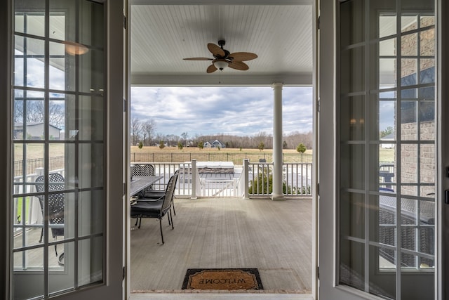 doorway with ceiling fan and a healthy amount of sunlight