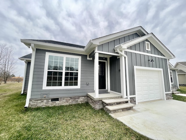 view of front of house with a front yard and a garage