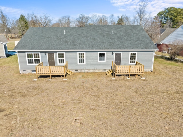 back of property with a wooden deck and a yard