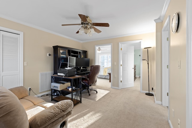 home office with carpet, ceiling fan, and crown molding